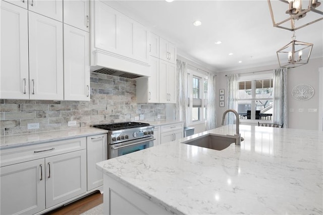 168 Brighton Blvd, Woodstock, GA 30188 - kitchen with stainless steel range, a sink, white cabinetry, backsplash, and ornamental molding