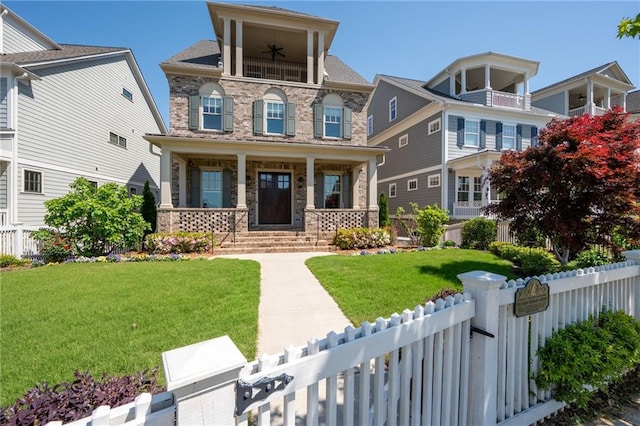168 Brighton Blvd, Woodstock, GA 30188 - view of front of house with a ceiling fan, covered porch, stone siding, and a balcony