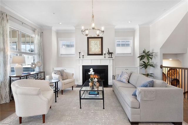 168 Brighton Blvd, Woodstock, GA 30188 - living room featuring ornamental molding, a chandelier, a glass covered fireplace, and recessed lighting
