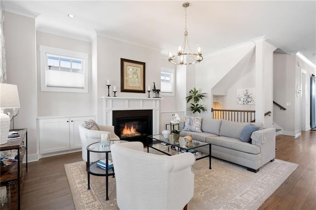 168 Brighton Blvd, Woodstock, GA 30188 - living area with a chandelier, ornamental molding, wood finished floors, a glass covered fireplace, and baseboards
