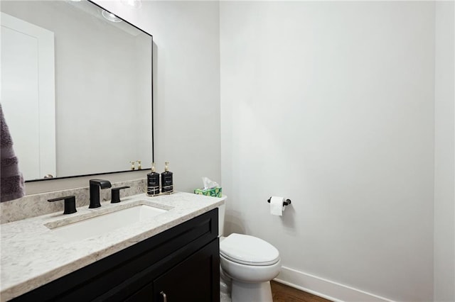 168 Brighton Blvd, Woodstock, GA 30188 - half bathroom with vanity, toilet, wood finished floors, and baseboards