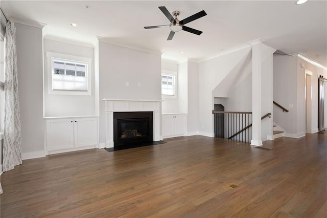 168 Brighton Blvd, Woodstock, GA 30188 - unfurnished living room with ornamental molding, wood finished floors, a ceiling fan, a fireplace with flush hearth, and baseboards