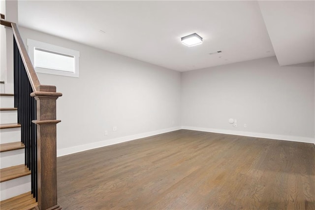 168 Brighton Blvd, Woodstock, GA 30188 - spare room with wood finished floors, baseboards, and stairway
