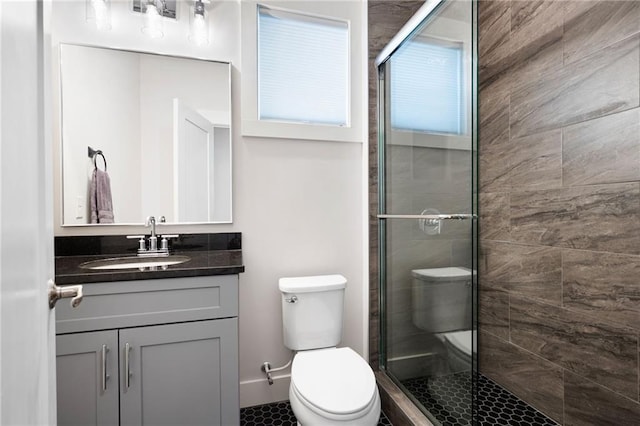 168 Brighton Blvd, Woodstock, GA 30188 - bathroom featuring toilet, a shower stall, vanity, and tile patterned flooring