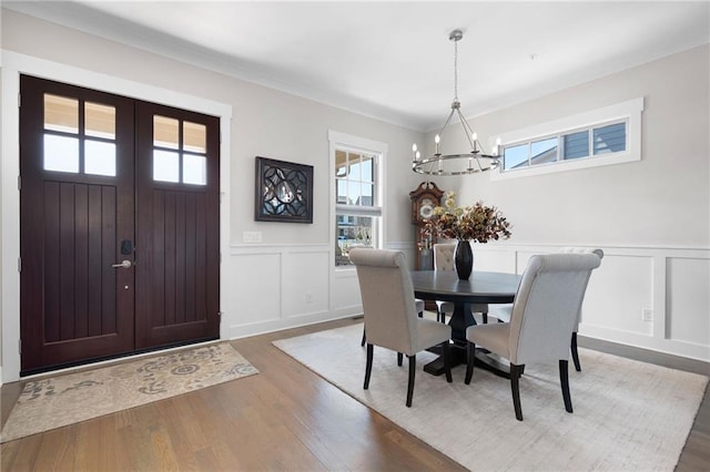 168 Brighton Blvd, Woodstock, GA 30188 - dining room with a chandelier, plenty of natural light, a decorative wall, wood finished floors, and wainscoting