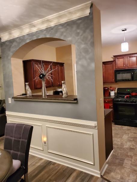 interior space featuring crown molding and black appliances