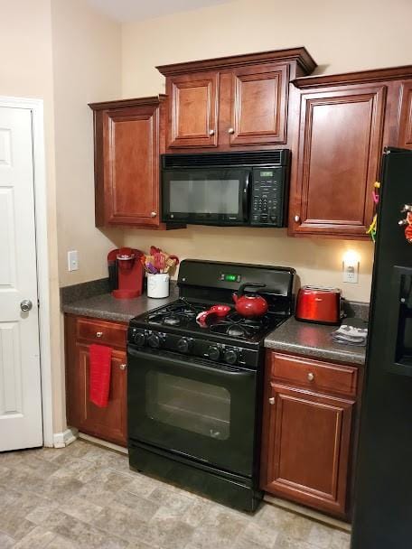 kitchen featuring dark countertops and black appliances