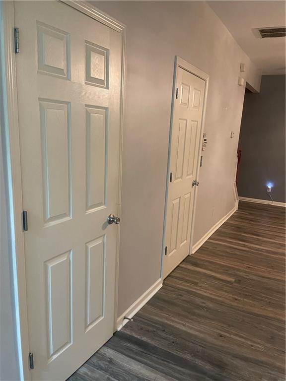 2118 Burns View Ln, Lawrenceville, GA 30044 - hallway with dark wood finished floors and baseboards