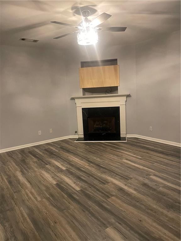 2118 Burns View Ln, Lawrenceville, GA 30044 - unfurnished living room featuring a ceiling fan, dark wood-type flooring, baseboards, and a fireplace