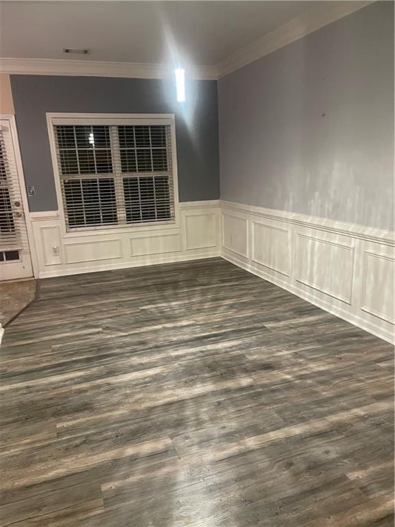 2118 Burns View Ln, Lawrenceville, GA 30044 - spare room featuring wainscoting, dark wood-style floors, crown molding, and a decorative wall