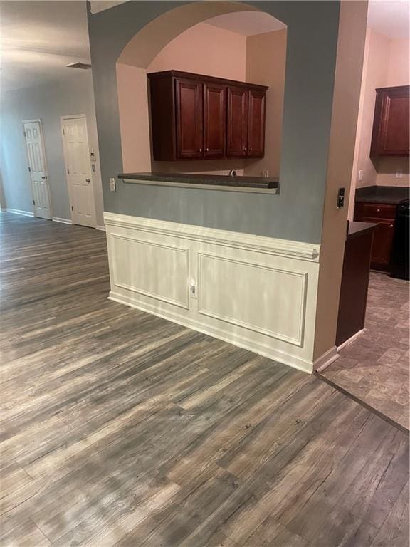 2118 Burns View Ln, Lawrenceville, GA 30044 - unfurnished dining area with dark wood-style floors and a wainscoted wall