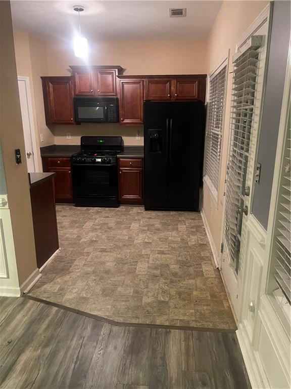 2118 Burns View Ln, Lawrenceville, GA 30044 - kitchen featuring black appliances, dark countertops, and dark brown cabinets