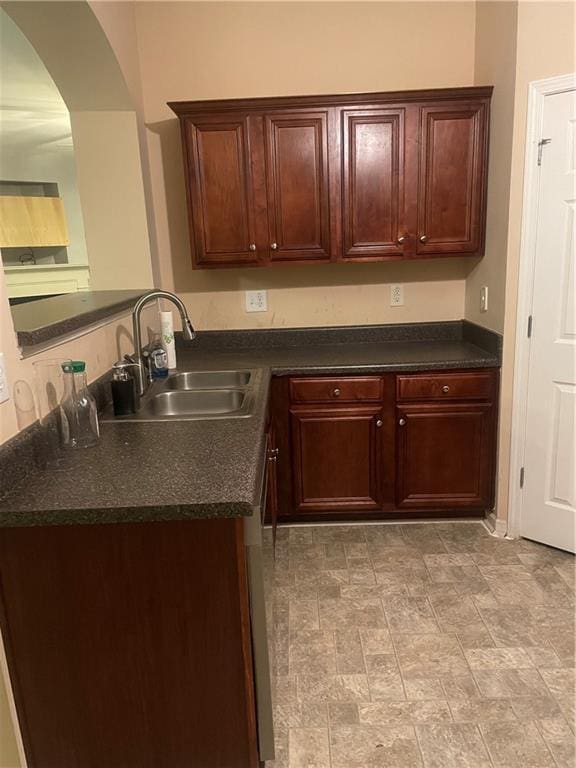 2118 Burns View Ln, Lawrenceville, GA 30044 - kitchen featuring dark countertops, a sink, arched walkways, dishwasher, and a peninsula