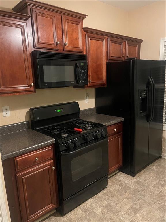 2118 Burns View Ln, Lawrenceville, GA 30044 - kitchen featuring black appliances and dark countertops