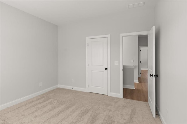 unfurnished bedroom with light colored carpet