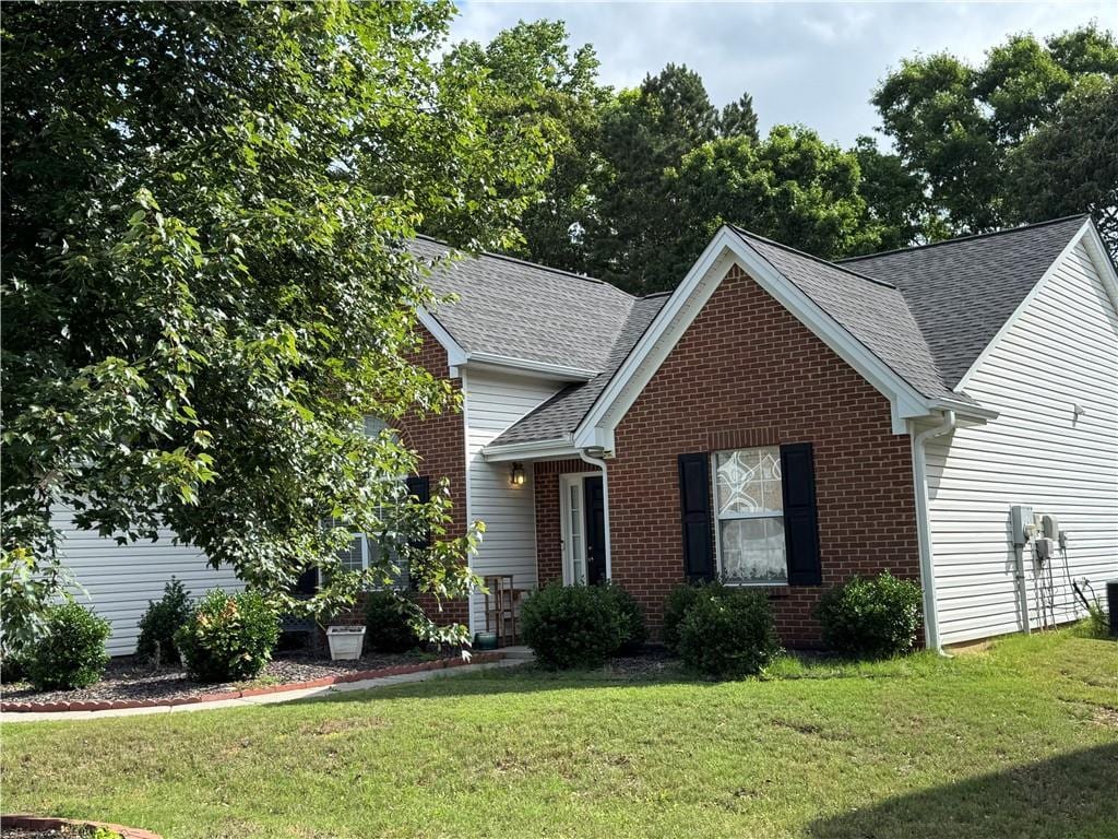 3690 Crescent Walk Ln, Suwanee, GA 30024 - traditional home with brick siding, a front yard, a shingled roof, and cooling unit