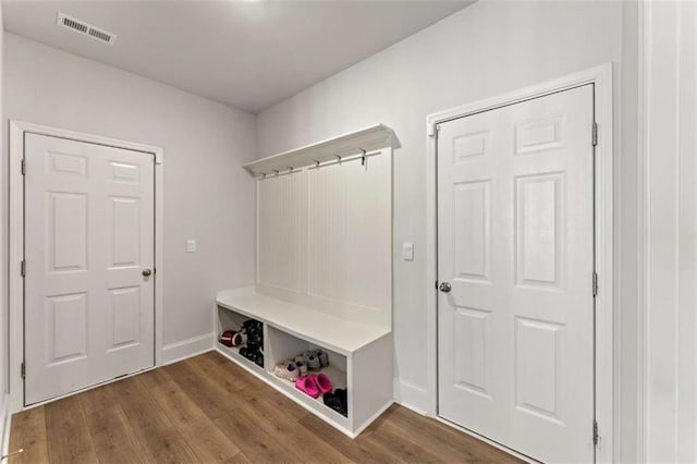 mudroom with visible vents, baseboards, and wood finished floors