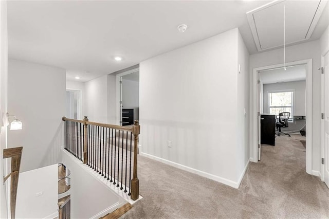 corridor with an upstairs landing, recessed lighting, carpet flooring, baseboards, and attic access