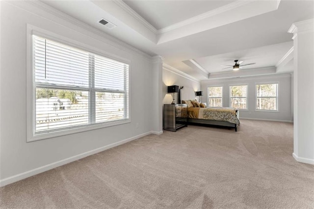 bedroom featuring baseboards, carpet floors, visible vents, a tray ceiling, and crown molding