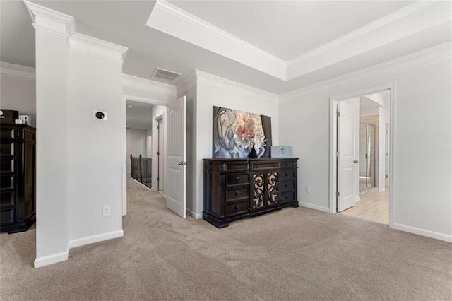 corridor featuring a raised ceiling, carpet, baseboards, and ornamental molding