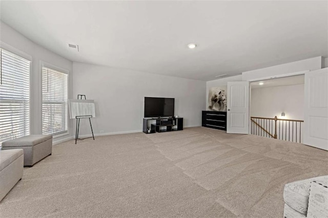 sitting room with visible vents, baseboards, recessed lighting, an upstairs landing, and light colored carpet