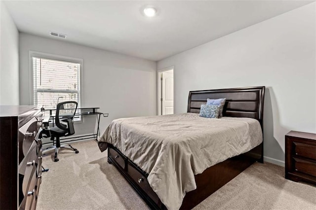 bedroom featuring visible vents, baseboards, and light colored carpet