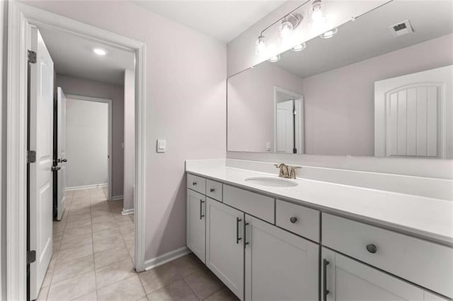 bathroom featuring tile patterned floors, visible vents, vanity, and baseboards