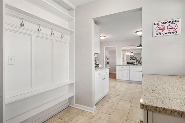 mudroom with a chandelier