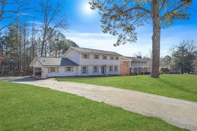 view of front of house with a garage and a front lawn