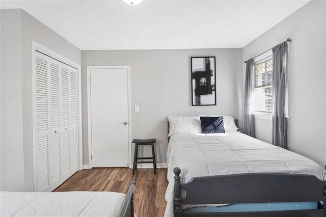 bedroom with a closet and dark hardwood / wood-style flooring