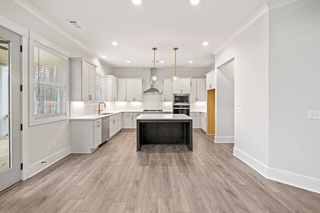 3390 Hillshire Dr, Cumming, GA 30028 - kitchen featuring stainless steel appliances, a sink, wall chimney range hood, decorative backsplash, and light countertops