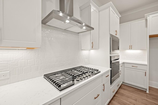 3390 Hillshire Dr, Cumming, GA 30028 - kitchen with wall chimney range hood, appliances with stainless steel finishes, light countertops, decorative backsplash, and crown molding