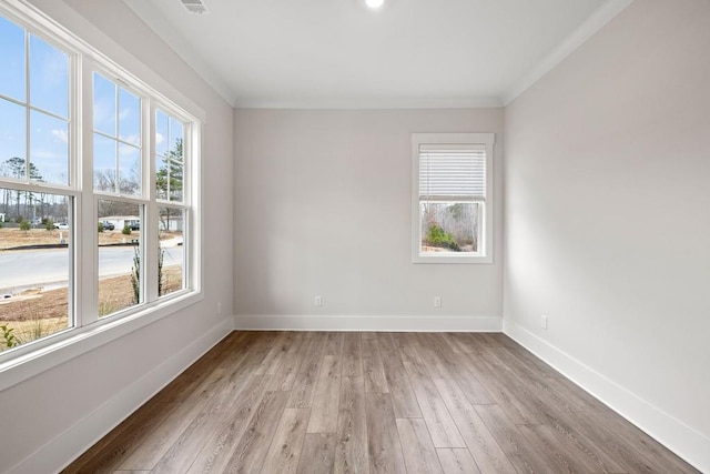 3390 Hillshire Dr, Cumming, GA 30028 - unfurnished room featuring healthy amount of natural light, baseboards, light wood-style floors, and crown molding