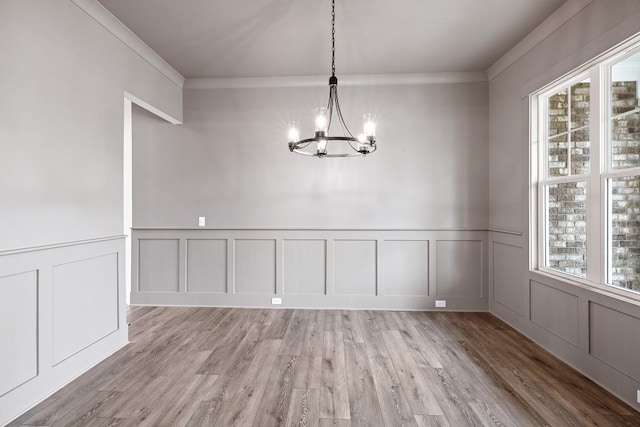 3390 Hillshire Dr, Cumming, GA 30028 - unfurnished dining area with a decorative wall, a chandelier, crown molding, plenty of natural light, and light wood finished floors
