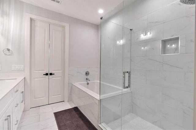 6890 Peachtree Dunwoody Rd Unit 303, Atlanta, GA 30328 - bathroom featuring marble finish flooring, a marble finish shower, vanity, a garden tub, and recessed lighting