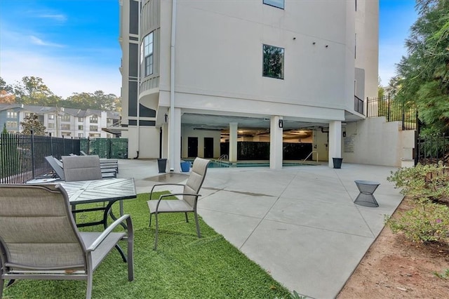 6890 Peachtree Dunwoody Rd Unit 303, Atlanta, GA 30328 - rear view of house with a patio area and stairs