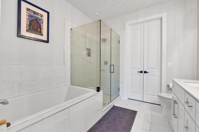 6890 Peachtree Dunwoody Rd Unit 303, Atlanta, GA 30328 - bathroom featuring a stall shower, marble look tile flooring, vanity, a garden tub, and toilet