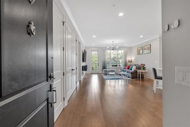6890 Peachtree Dunwoody Rd Unit 303, Atlanta, GA 30328 - entryway with crown molding, baseboards, hardwood / wood-style floors, a chandelier, and recessed lighting