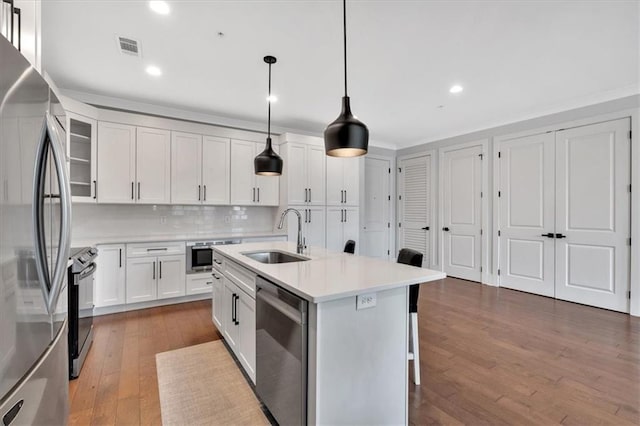 6890 Peachtree Dunwoody Rd Unit 303, Atlanta, GA 30328 - kitchen with a sink, appliances with stainless steel finishes, light countertops, decorative backsplash, and hardwood / wood-style floors