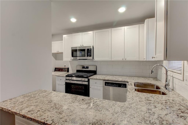 3252 Abbeywood Dr, Decatur, GA 30034 - kitchen featuring stainless steel appliances, a sink, light stone counters, backsplash, and a peninsula