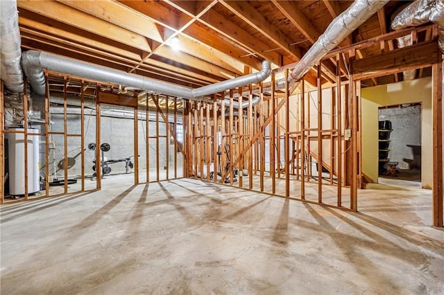 miscellaneous room featuring water heater and concrete floors