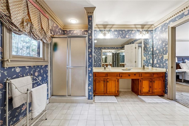 bathroom with vanity, an enclosed shower, and ornamental molding