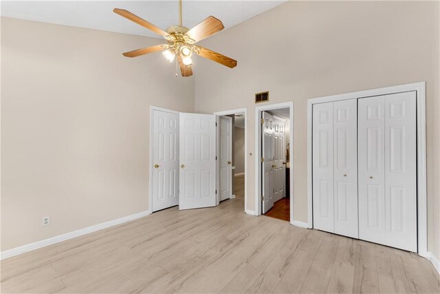 spare room featuring ceiling fan, sink, vaulted ceiling, and light wood-type flooring