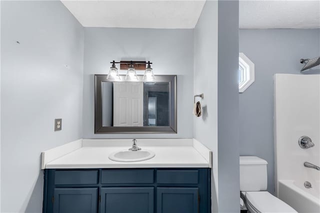 full bathroom with toilet, shower / washtub combination, a textured ceiling, and vanity