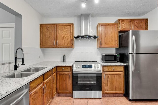 kitchen with light stone counters, island range hood, range, and backsplash