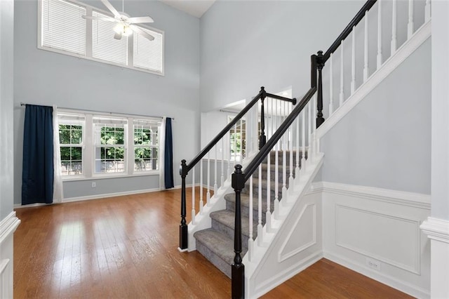 3362 Palm Cir NW, Kennesaw, GA 30144 - staircase featuring wood-type flooring, a towering ceiling, and ceiling fan