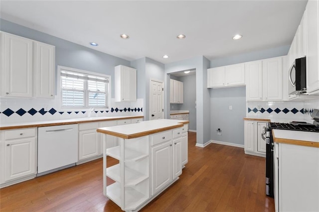 3362 Palm Cir NW, Kennesaw, GA 30144 - kitchen featuring white dishwasher, gas stove, stainless steel microwave, tasteful backsplash, and open shelves