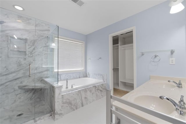 3362 Palm Cir NW, Kennesaw, GA 30144 - bathroom featuring a bath, a marble finish shower, double vanity, and a spacious closet