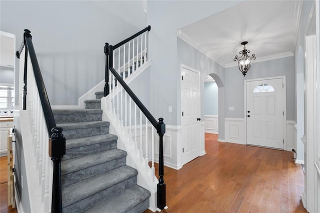 3362 Palm Cir NW, Kennesaw, GA 30144 - entryway with arched walkways, wood finished floors, stairs, a wainscoted wall, and crown molding