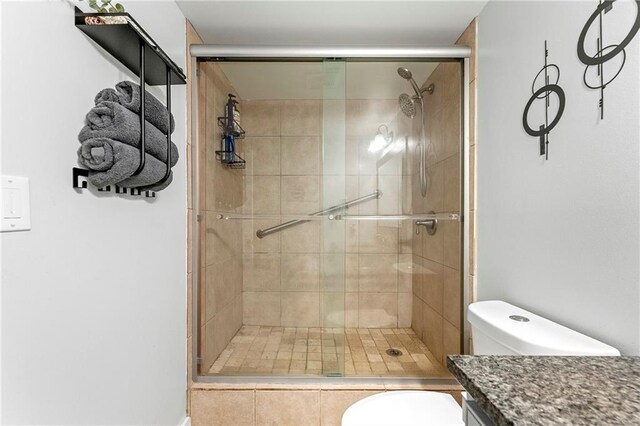 bathroom featuring walk in shower, vanity, and toilet